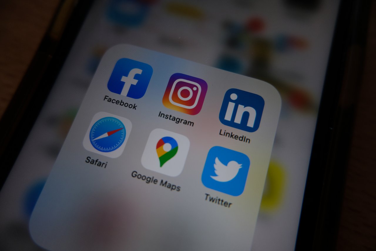 about-01 Close-up view of popular social media app icons on a smartphone screen.